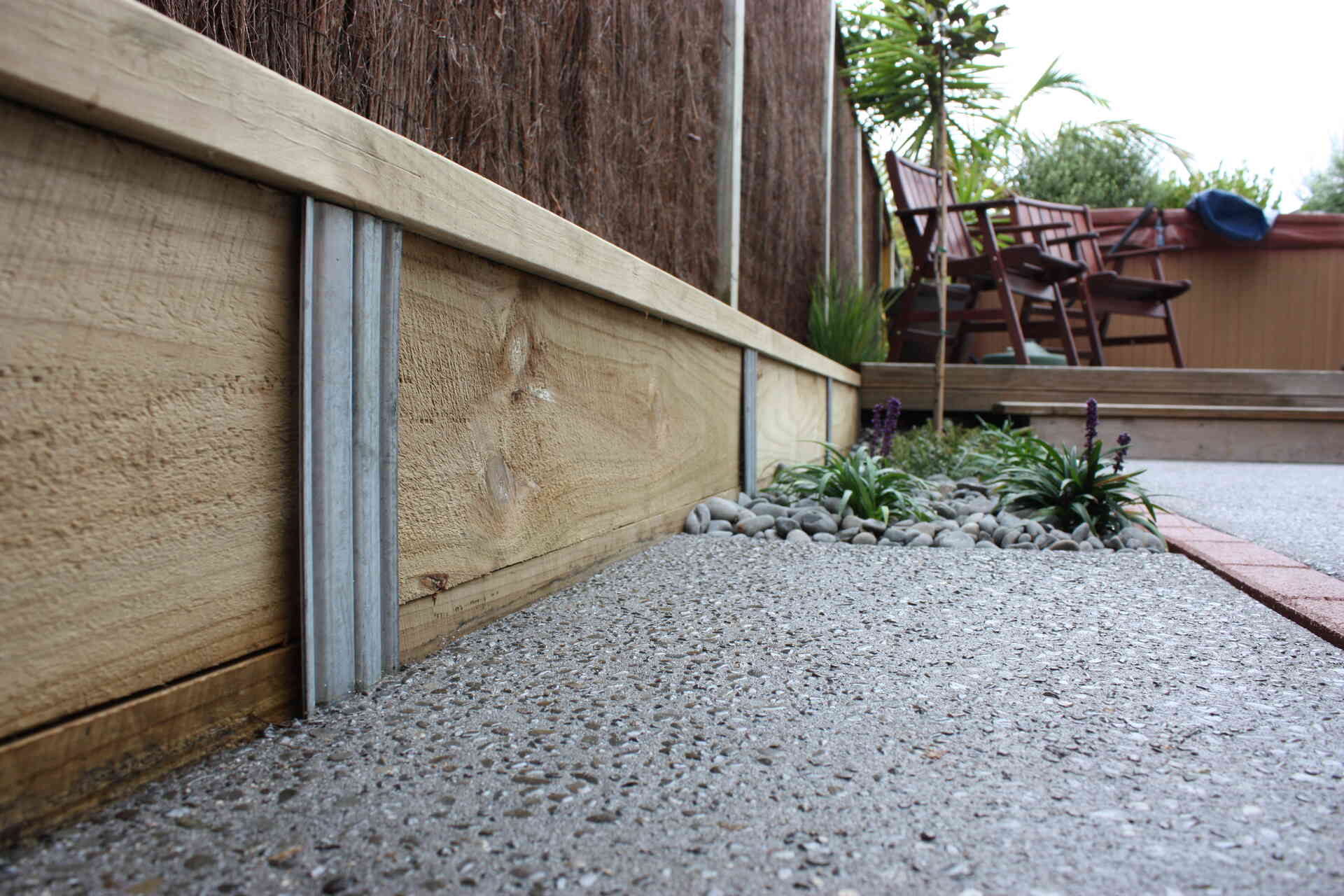 Sleeper retaining wall held in place with SureWall sleeper stakes