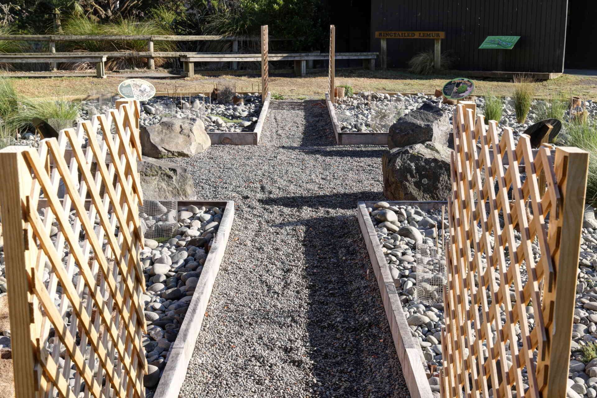 Finished PebbleLock gravel pathway with timber edging and lattice trellis panels