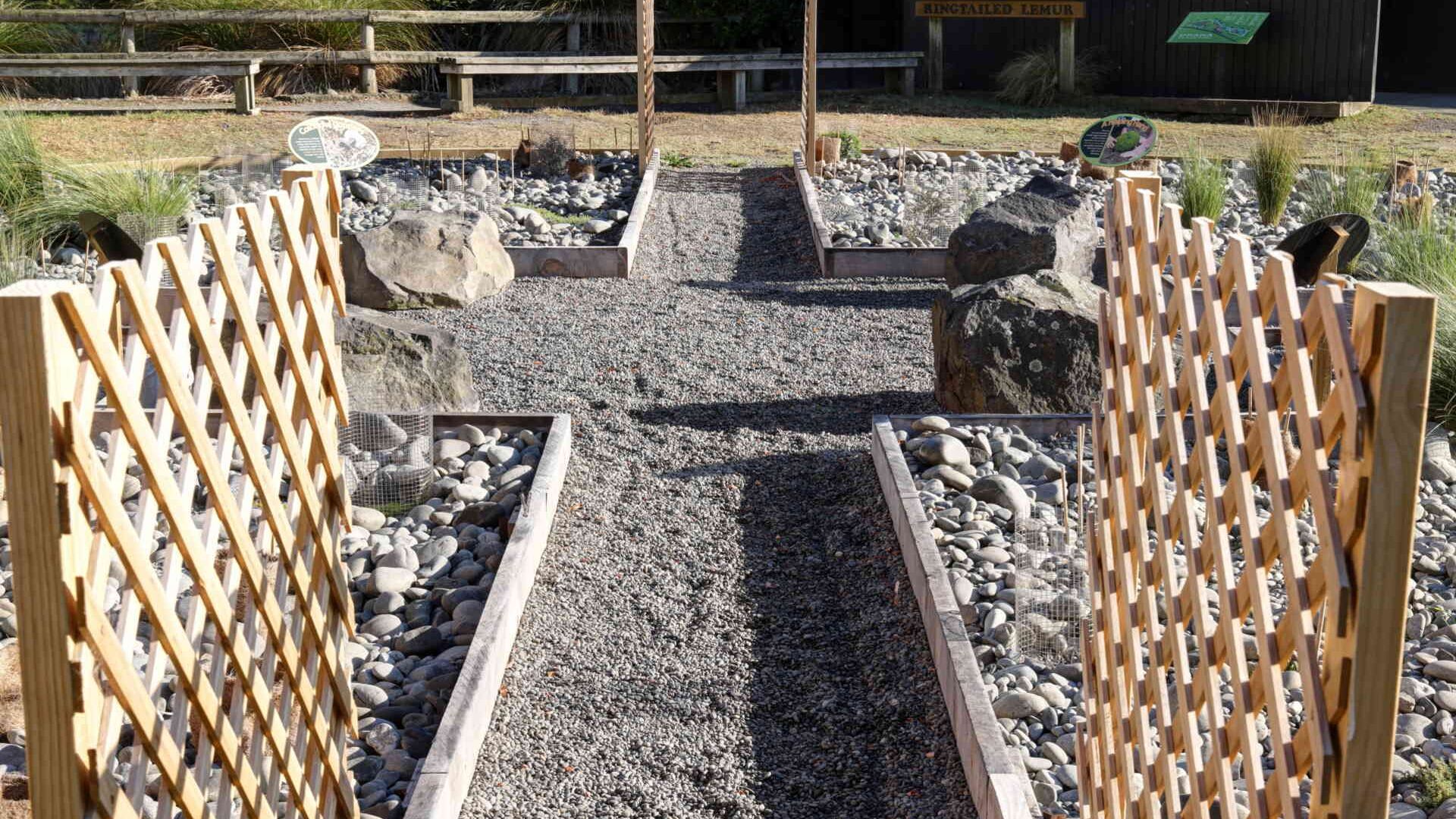 Finished PebbleLock gravel pathway with timber edging and lattice trellis panels