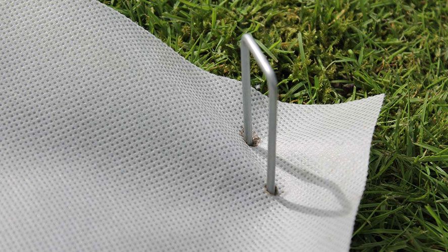 Staples pinning SmartMat Enviro weed mat